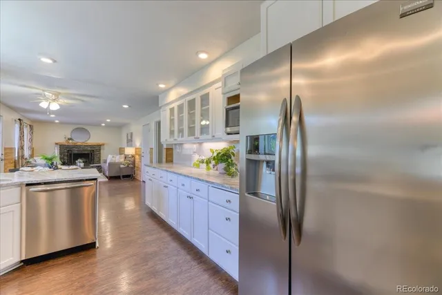 a kitchen with stainless steel appliances granite countertop a refrigerator a stove a sink and a refrigerator