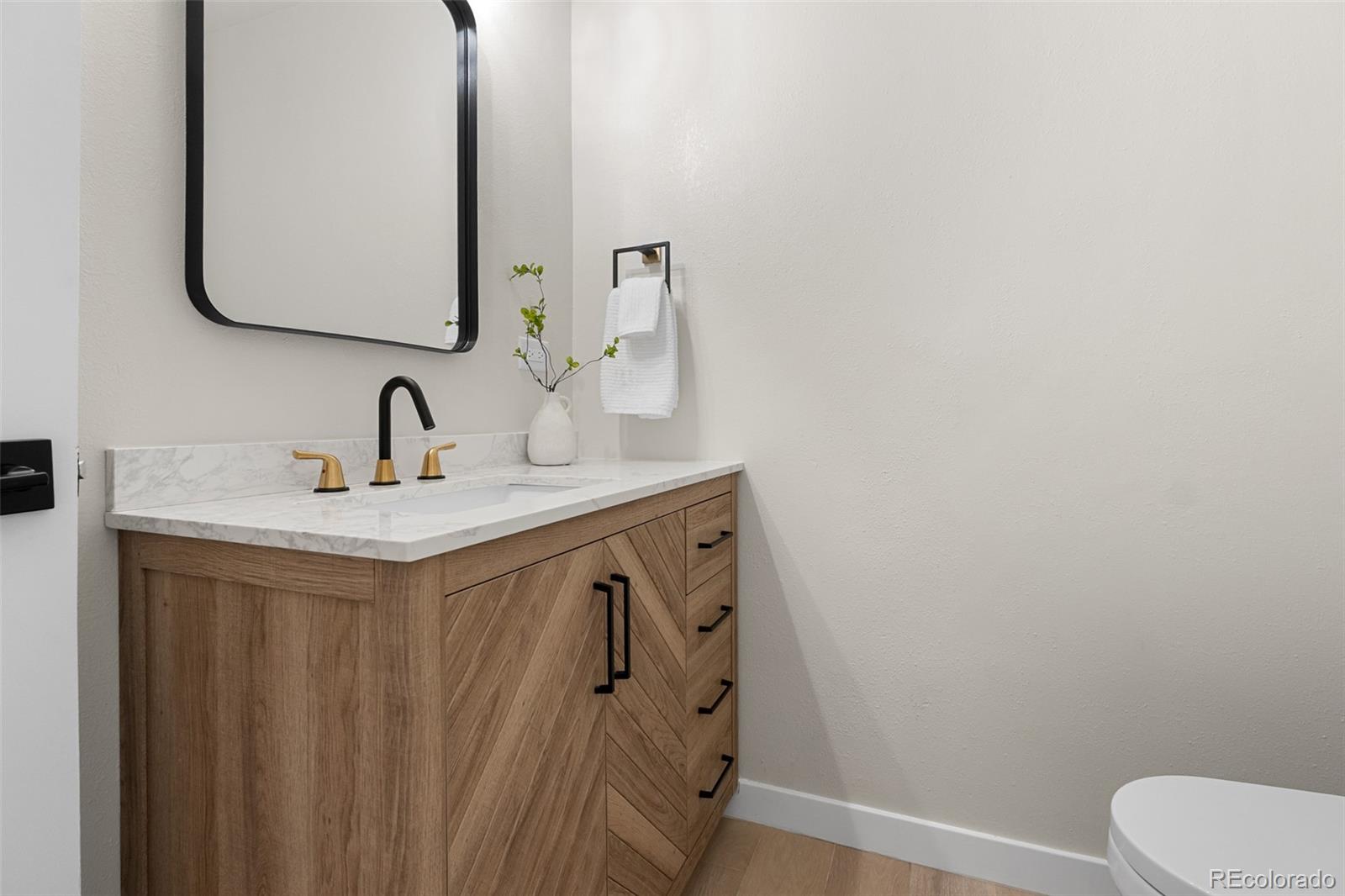367 North Clarkson Street Denver, CO 80218 - Photo 23 of 50 a bathroom with a sink vanity and a mirror