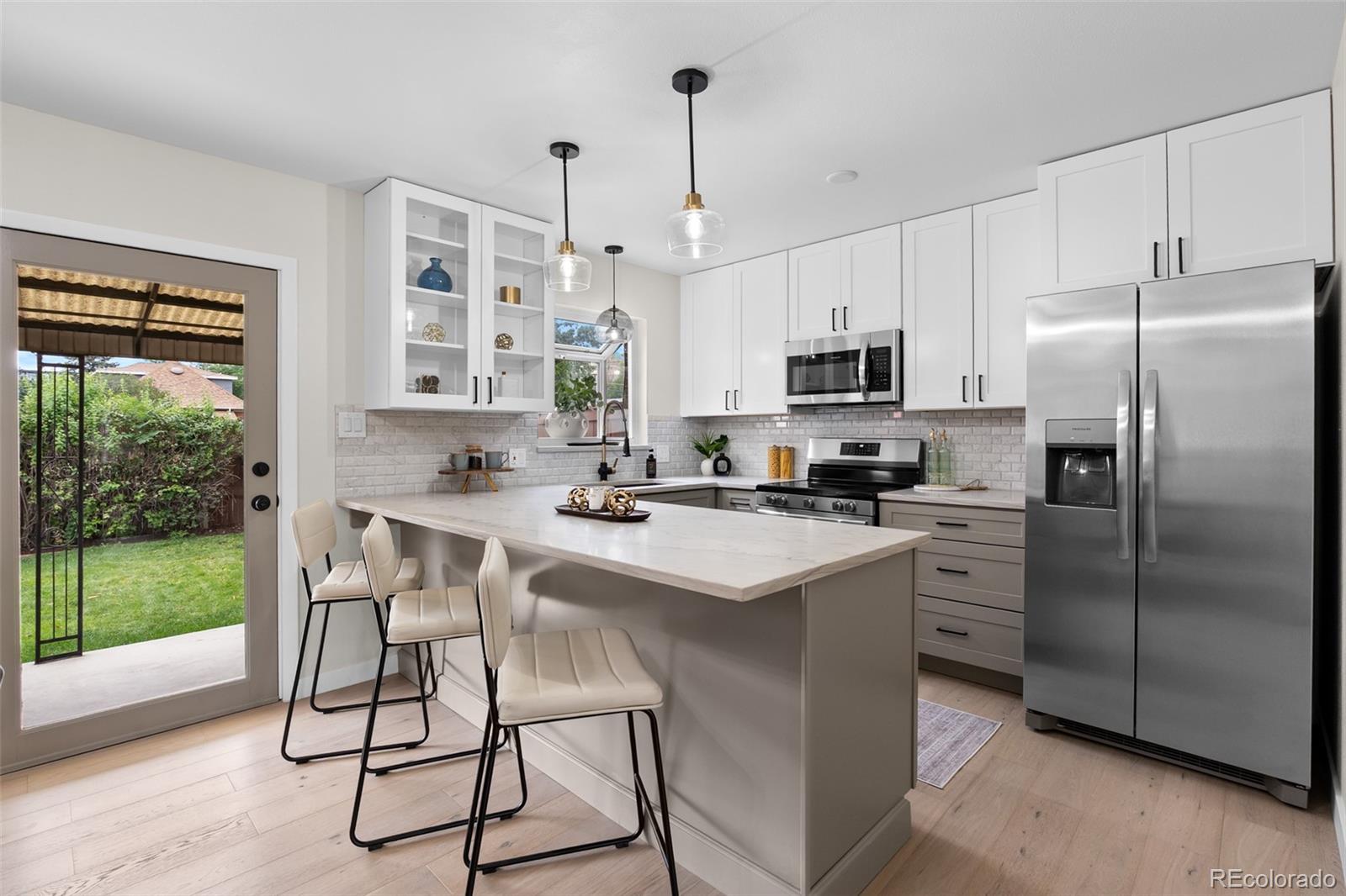 367 North Clarkson Street Denver, CO 80218 - Photo 4 of 50 a kitchen with stainless steel appliances a stove a sink refrigerator and a microwave