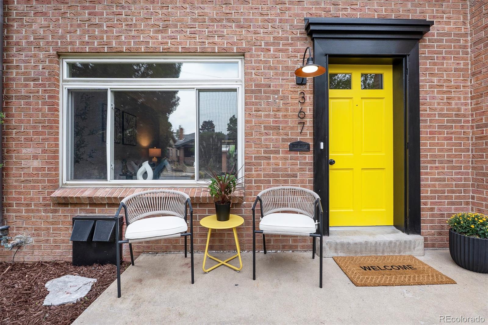 367 North Clarkson Street Denver, CO 80218 - Photo 8 of 50 a view of a brick house with a chairs and a table