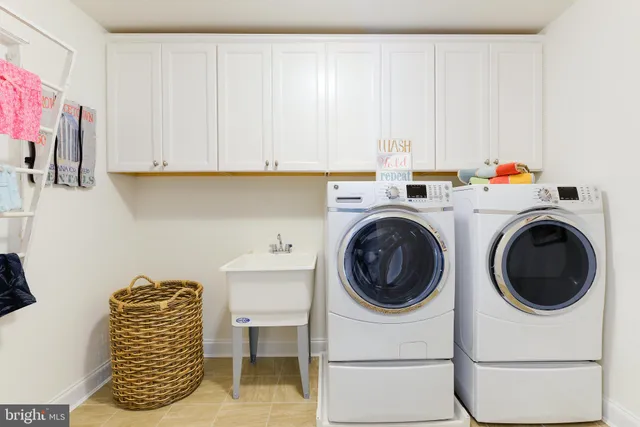 a living room with furniture a table and kitchen view