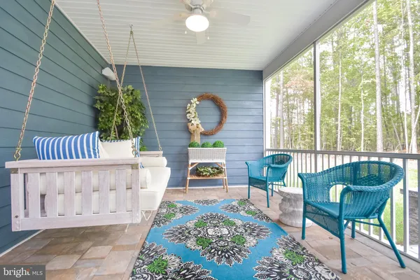 a view of a patio with couches table and chairs potted plants and palm tree