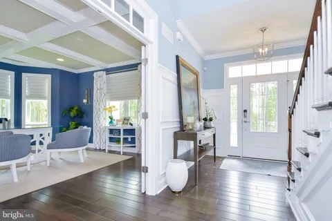 a view of a hallway with wooden floor and entryway