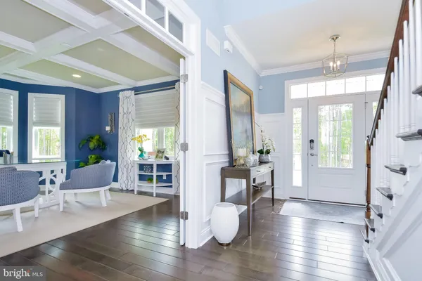 a view of a hallway with wooden floor and entryway