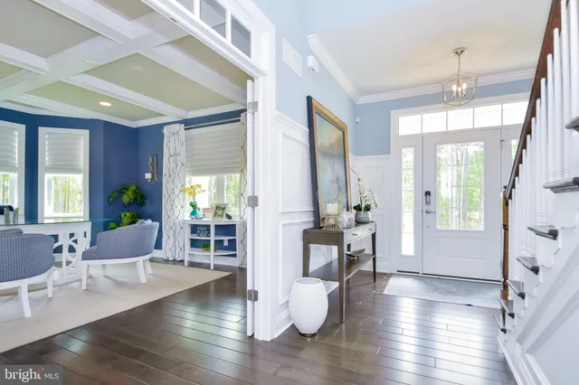 a view of a hallway with wooden floor and entryway