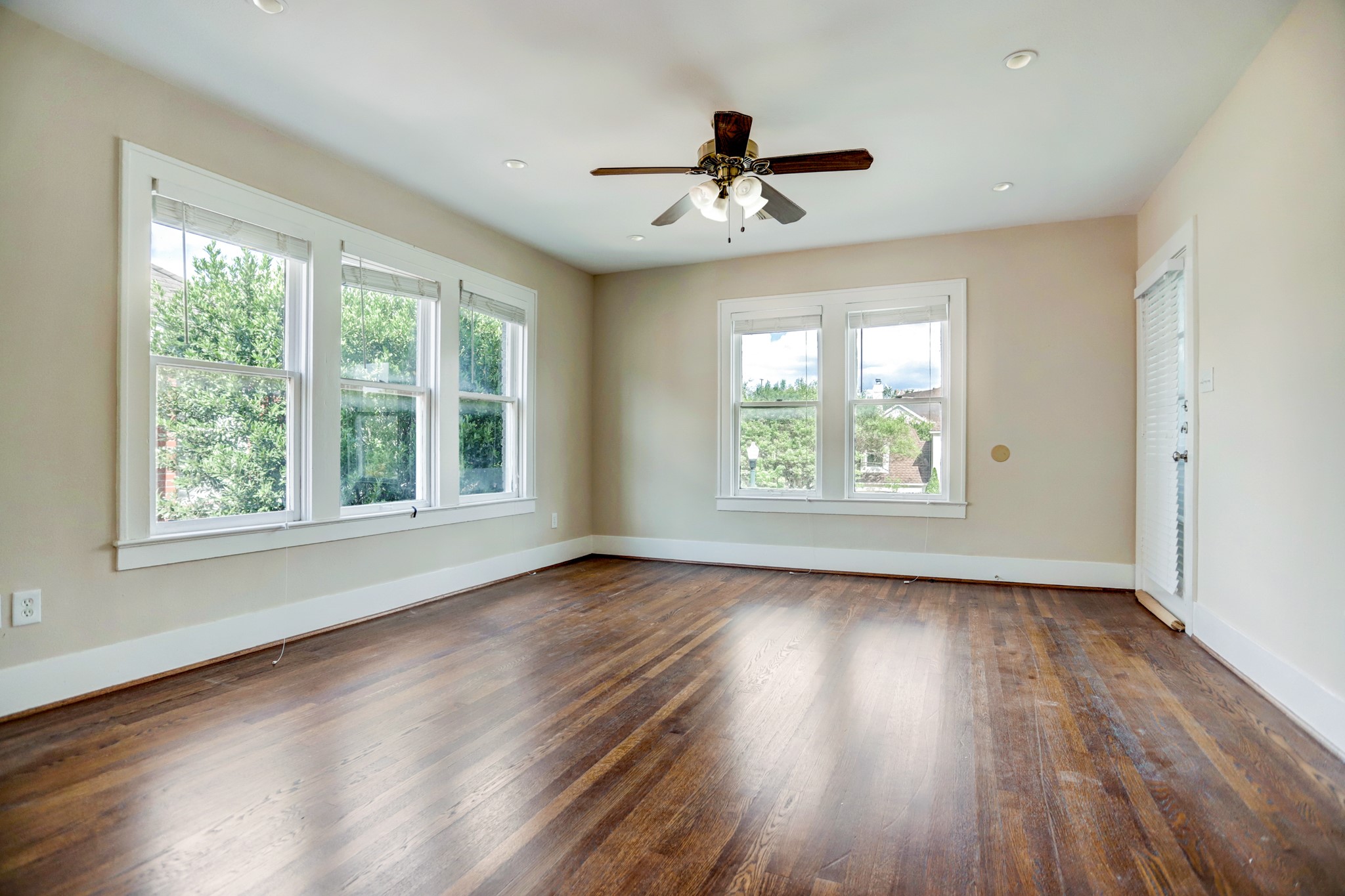 2510 Kingston Street, Unit 1 Houston, TX 77019 - Photo 3 of 8 a view of an empty room with wooden floor and a window