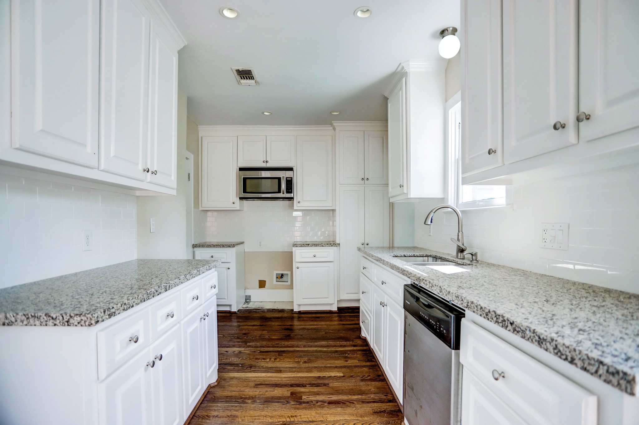 2510 Kingston Street, Unit 1 Houston, TX 77019 - Photo 5 of 8 a kitchen with granite countertop white cabinets and stainless steel appliances