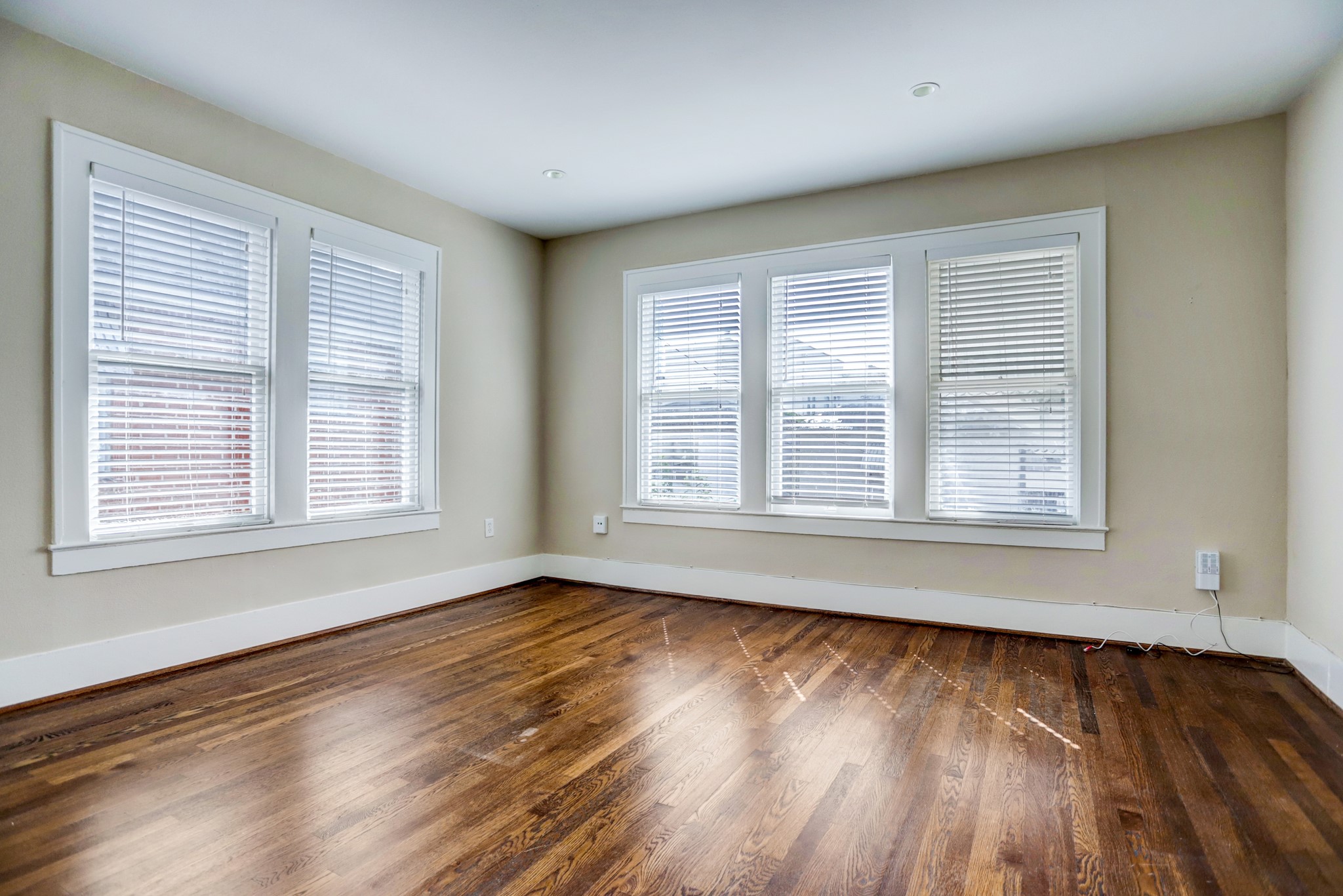 2510 Kingston Street, Unit 1 Houston, TX 77019 - Photo 6 of 8 a view of an empty room with wooden floor and a window