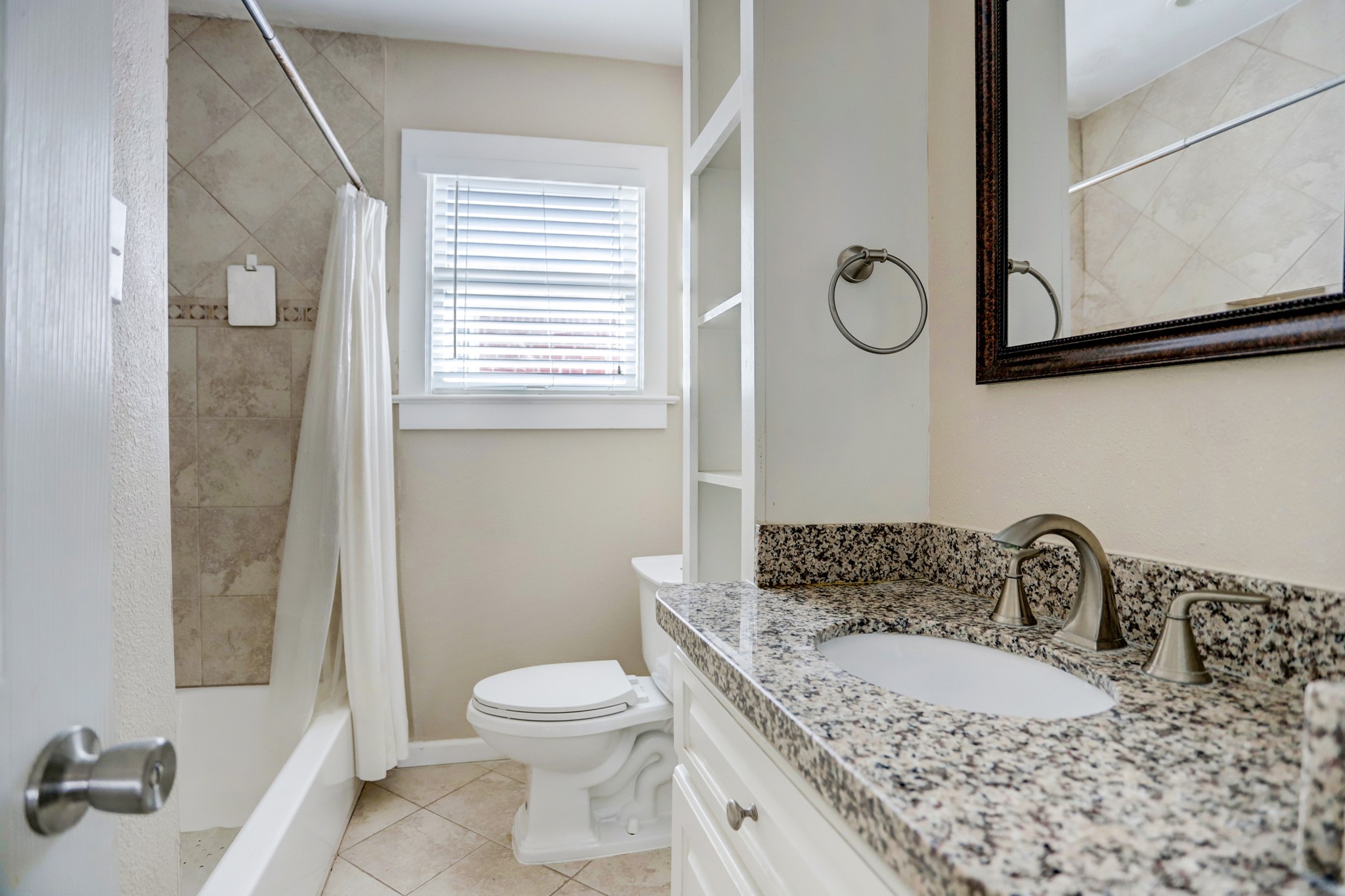 2510 Kingston Street, Unit 1 Houston, TX 77019 - Photo 7 of 8 a bathroom with a granite countertop sink toilet and a mirror