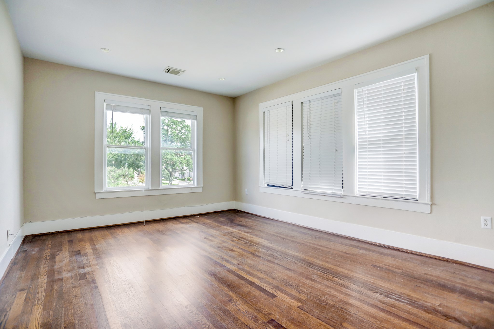 2510 Kingston Street, Unit 1 Houston, TX 77019 - Photo 8 of 8 an empty room with wooden floor and windows