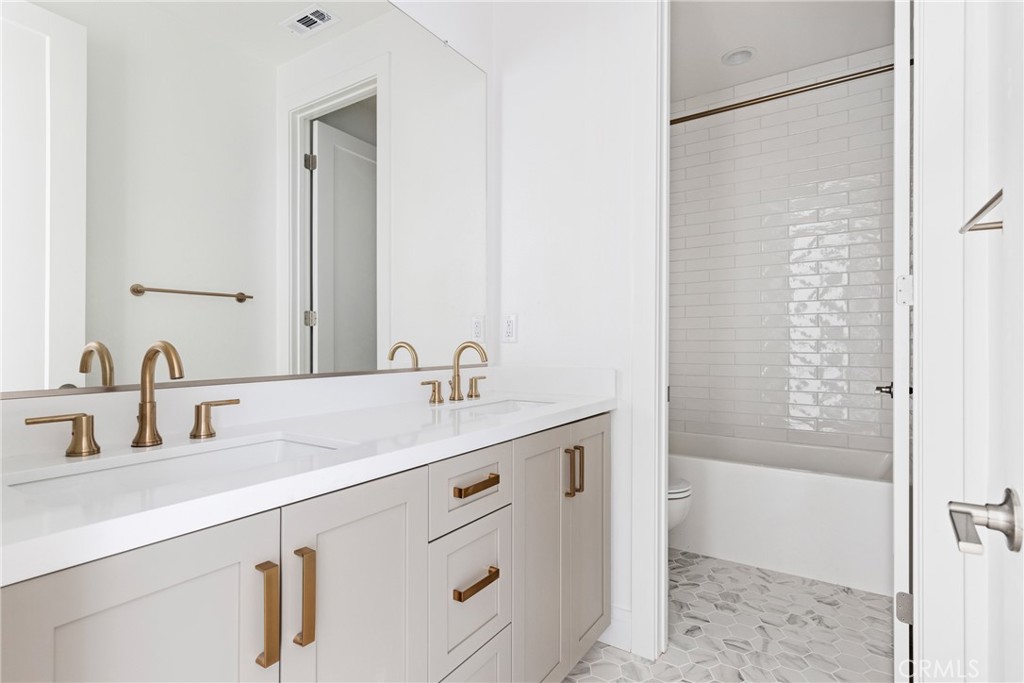 175 East Palm Street Altadena, CA 91001 - Photo 21 of 22 a bathroom with a shower sink and mirror