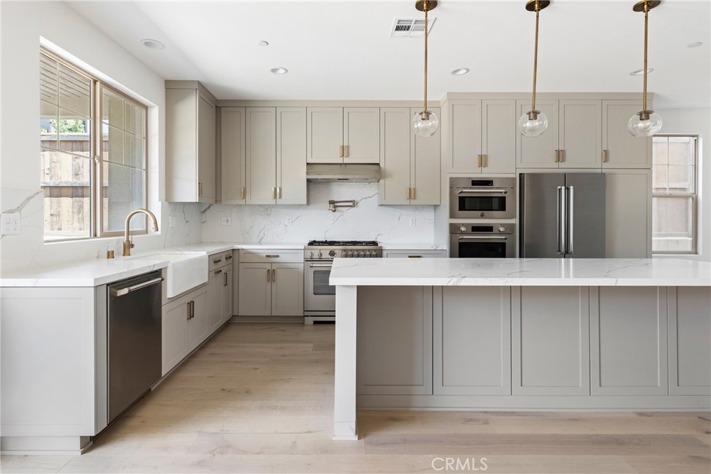 175 East Palm Street Altadena, CA 91001 - Photo 4 of 22 a kitchen with stainless steel appliances and white cabinets