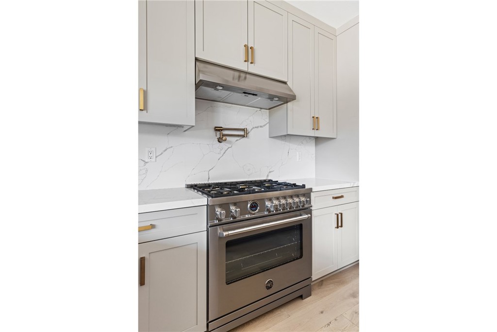 175 East Palm Street Altadena, CA 91001 - Photo 6 of 22 a kitchen with stainless steel appliances and white cabinets