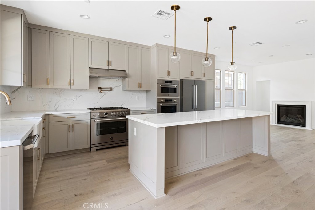 175 East Palm Street Altadena, CA 91001 - Photo 7 of 22 a kitchen with stainless steel appliances granite countertop a stove a sink and a refrigerator