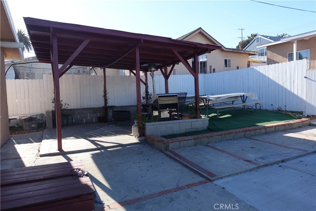 622 West 2nd Street San Pedro, CA 90731 - Photo 19 of 42 a view of a roof deck with table and chairs under an umbrella with wooden floor
