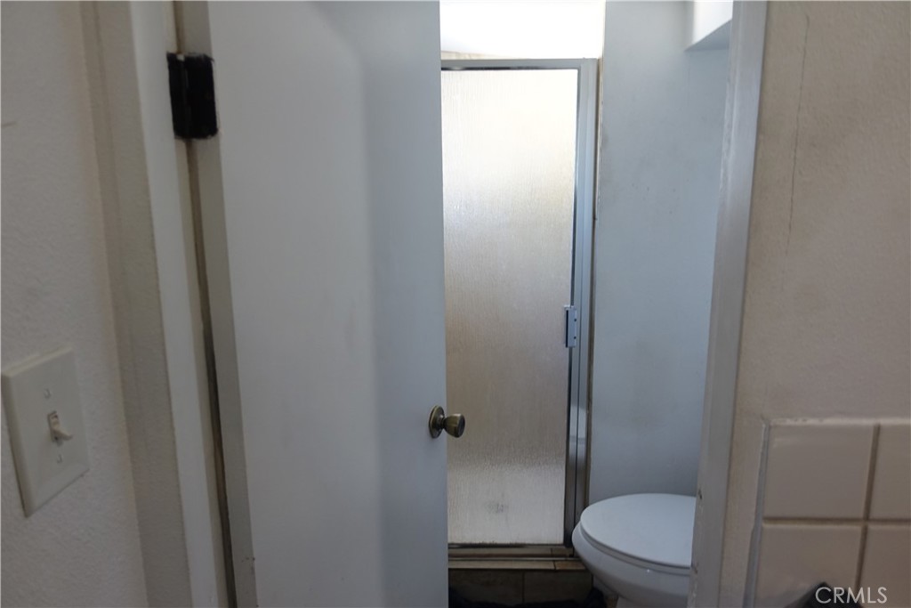 622 West 2nd Street San Pedro, CA 90731 - Photo 25 of 42 a bathroom with a toilet and a shower