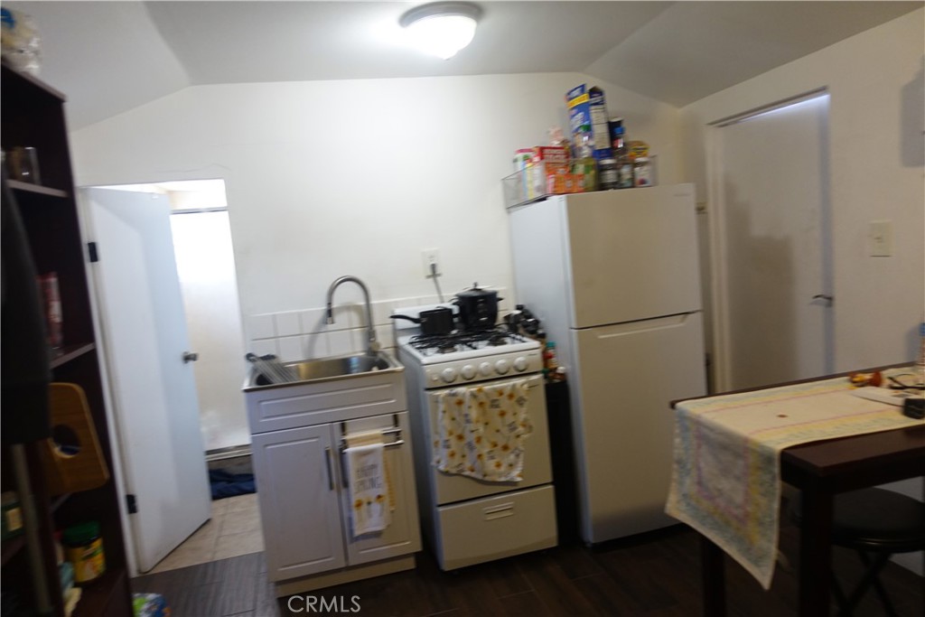 622 West 2nd Street San Pedro, CA 90731 - Photo 26 of 42 a kitchen with a refrigerator sink and white cabinets