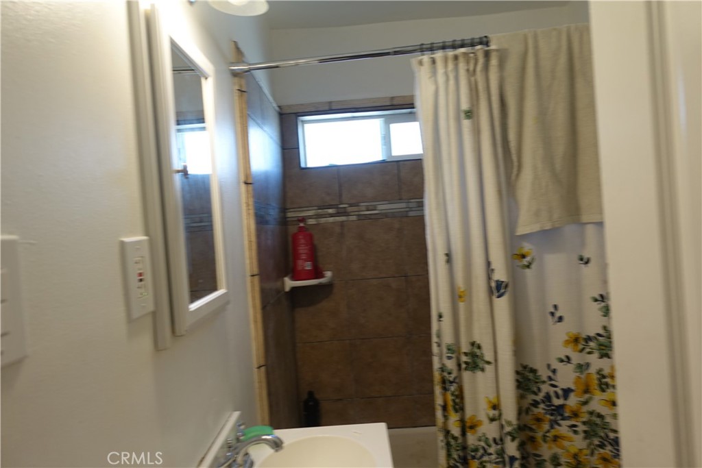 622 West 2nd Street San Pedro, CA 90731 - Photo 32 of 42 a bathroom with a shower and a toilet