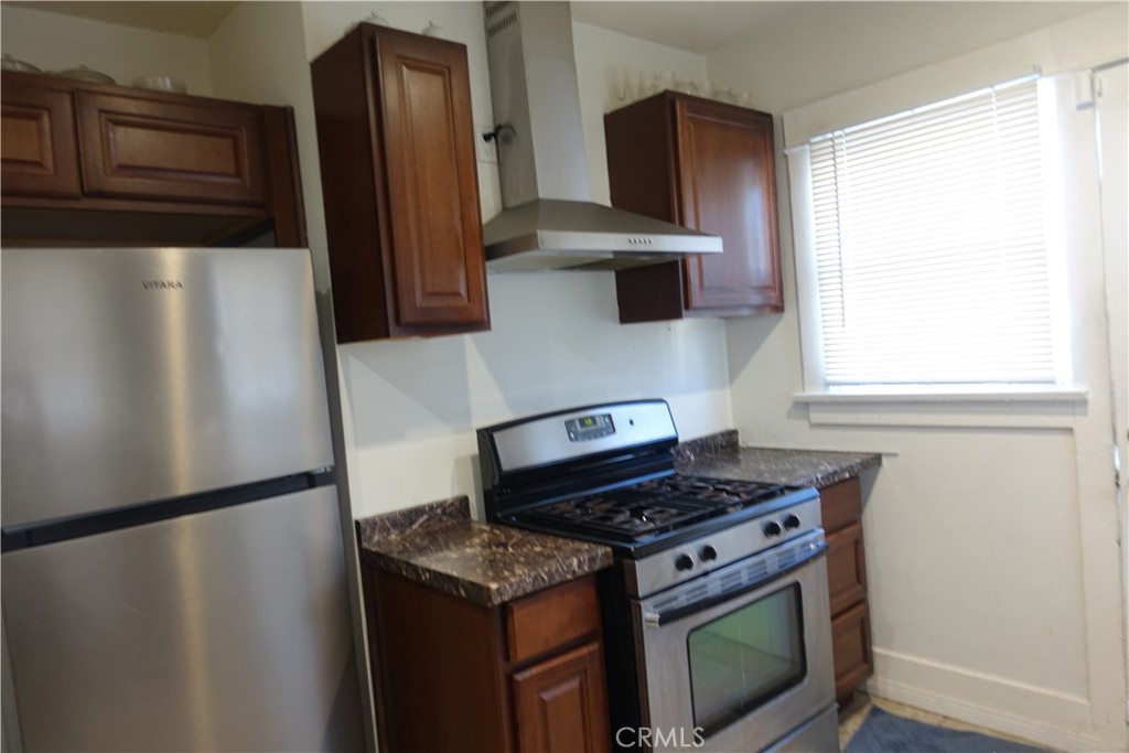622 West 2nd Street San Pedro, CA 90731 - Photo 6 of 42 a kitchen with stainless steel appliances granite countertop a refrigerator and a stove