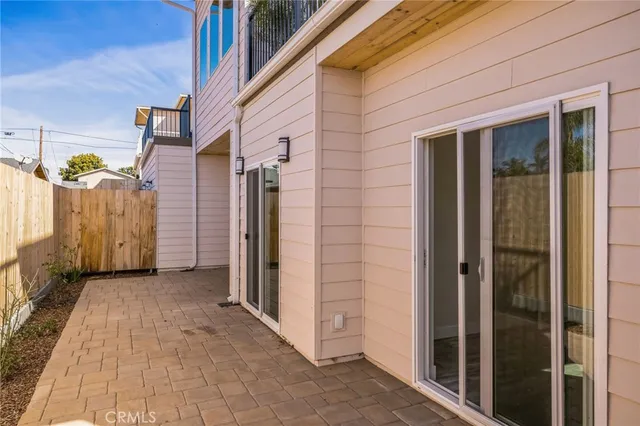 a view of a lake with couches and table under an umbrella next to a lake
