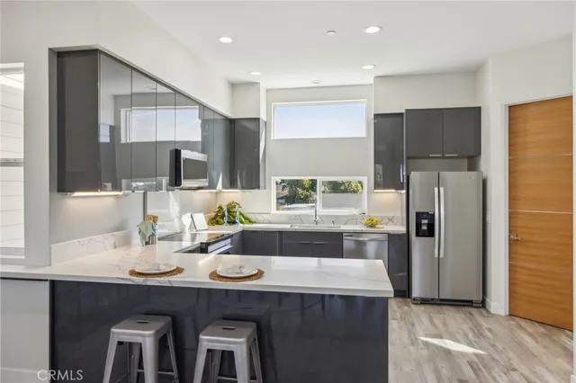 a kitchen with refrigerator cabinets and wooden floor