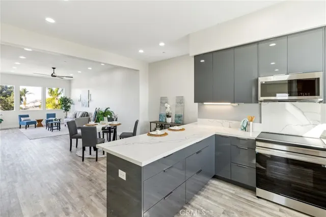a kitchen with a sink and chairs