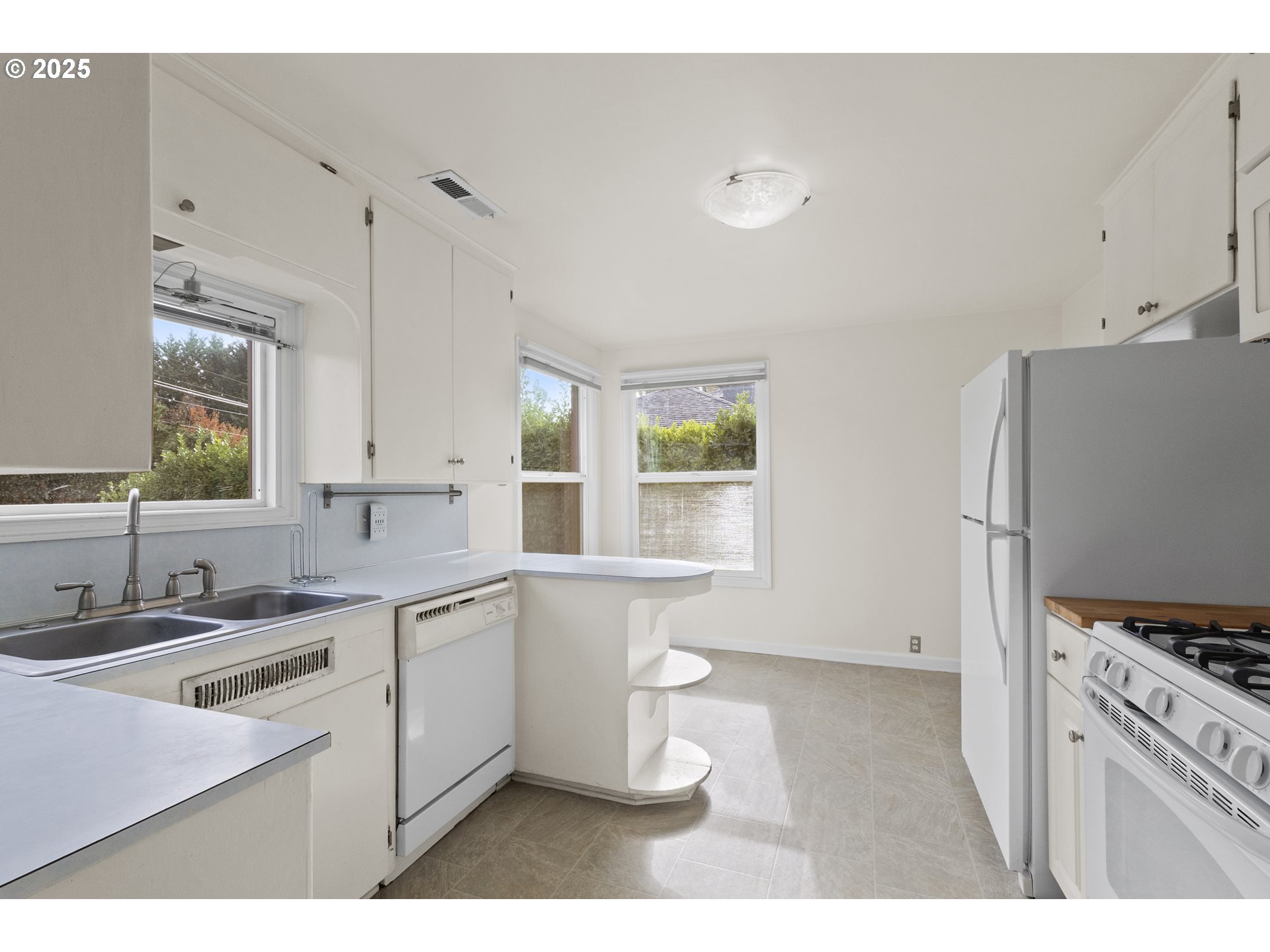707 Wynooski Street Newberg, OR 97132 - Photo 8 of 12 a kitchen with a sink stove and refrigerator