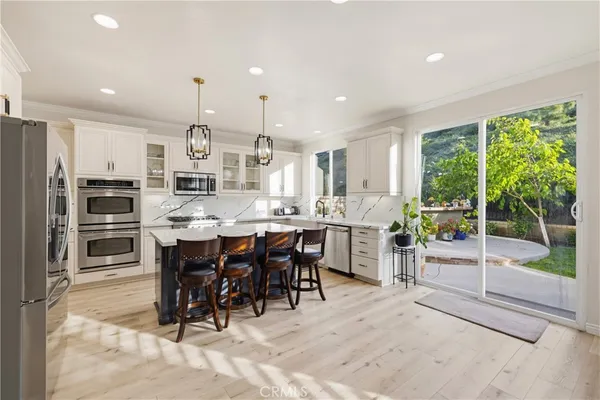 a kitchen with a sink stove top oven and refrigerator