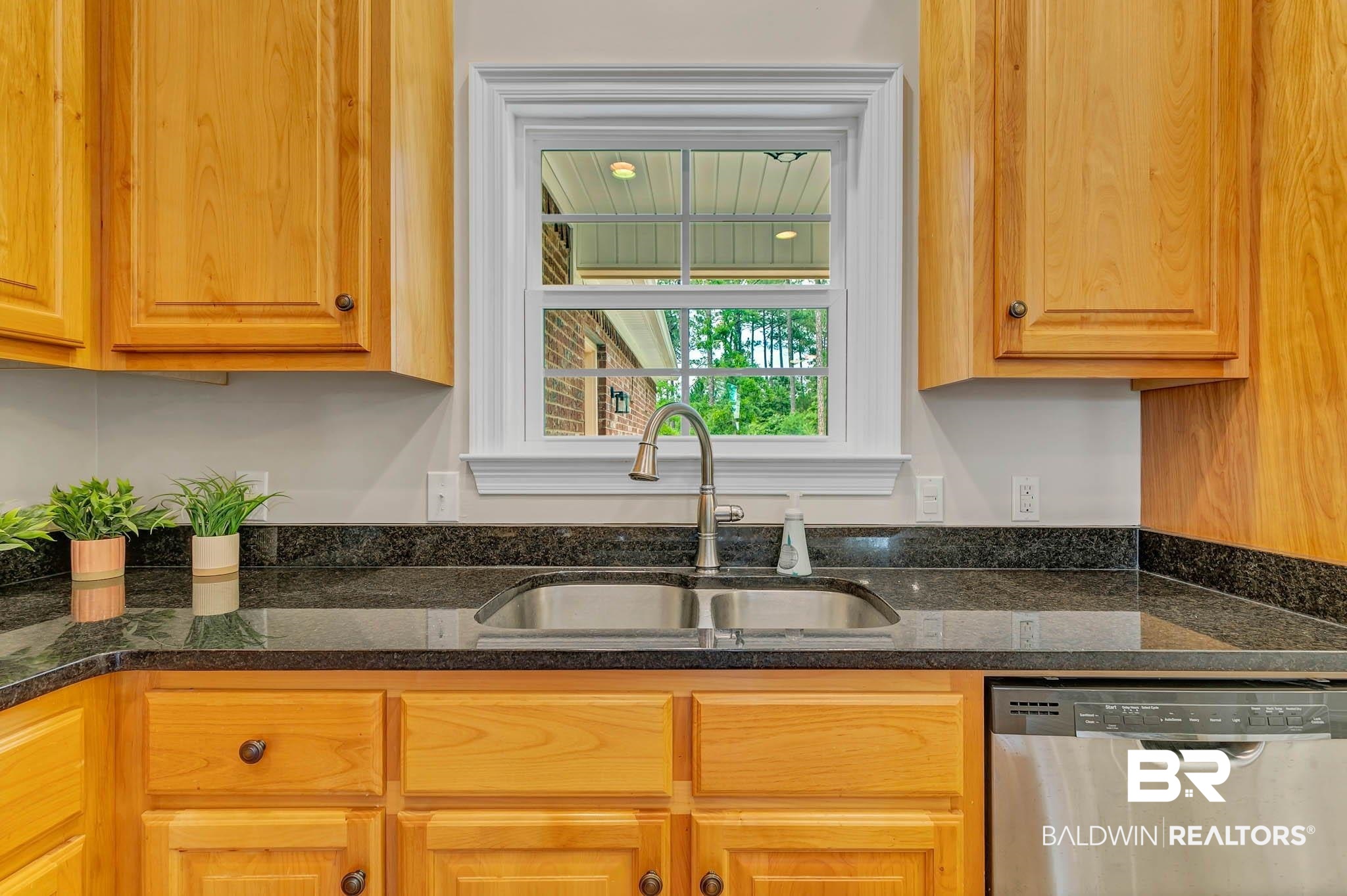 8145 Bay View Drive Foley, AL 36535 - Photo 24 of 81 Kitchen with dishwasher and dark stone counters