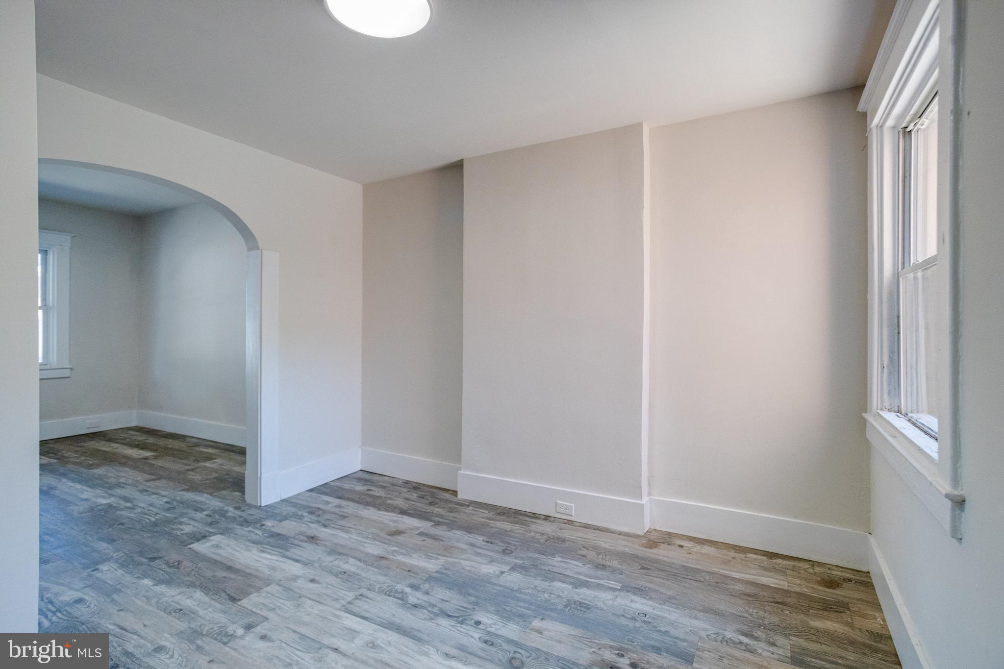 5878 Belair Road Baltimore, MD 21206 - Photo 12 of 41 a view of an empty room with wooden floor and a window