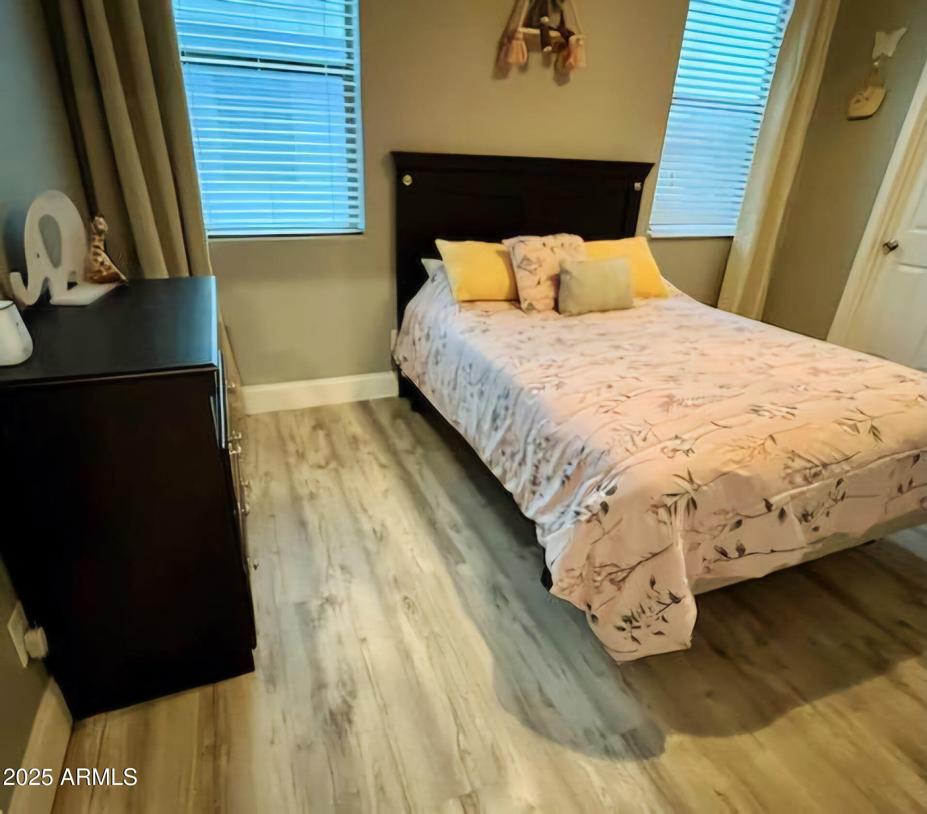 43578 West Cydnee Drive Maricopa, AZ 85138 - Photo 11 of 18 a bed sitting in a bedroom next to a window