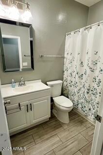 43578 West Cydnee Drive Maricopa, AZ 85138 - Photo 13 of 18 a bathroom with a granite countertop toilet a sink and a mirror