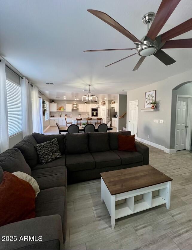 43578 West Cydnee Drive Maricopa, AZ 85138 - Photo 17 of 18 a living room with furniture ceiling fan and a rug