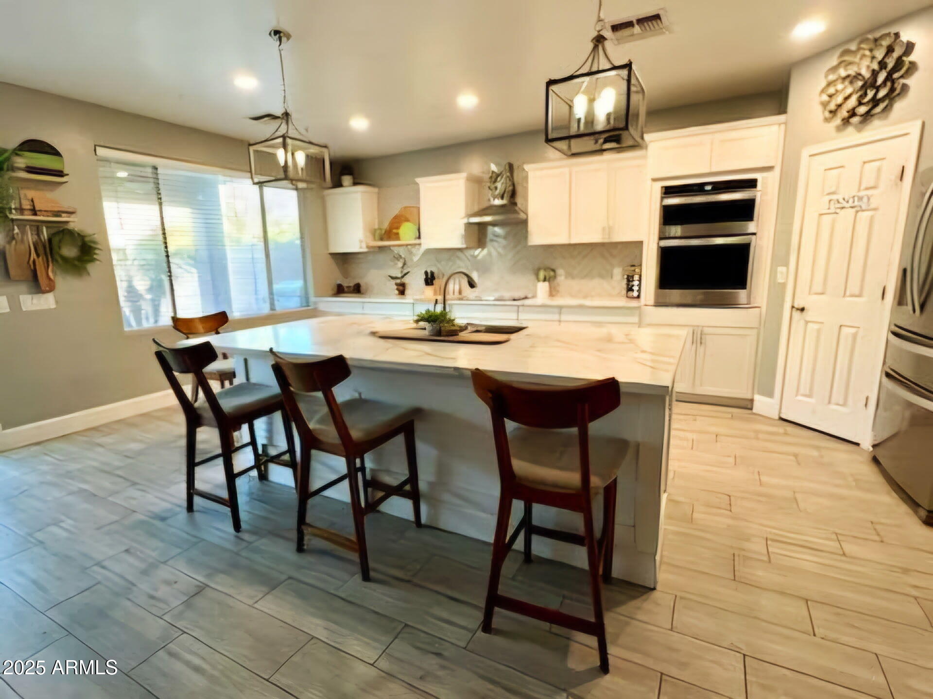 43578 West Cydnee Drive Maricopa, AZ 85138 - Photo 9 of 18 a kitchen with stainless steel appliances granite countertop a sink counter space and chairs in it