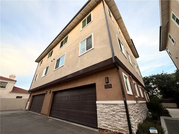 a front view of a house with garage