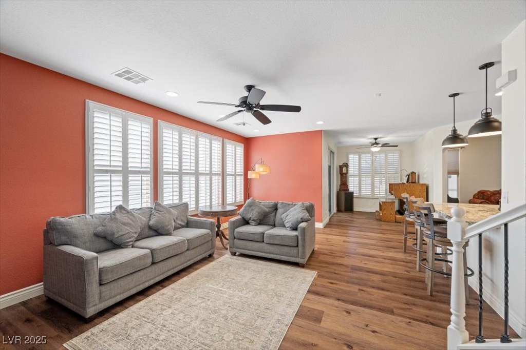 249 Cinnamon Ridge Way Henderson, NV 89015 - Photo 22 of 76 Living room with ceiling fan, wood finished floors, and recessed lighting