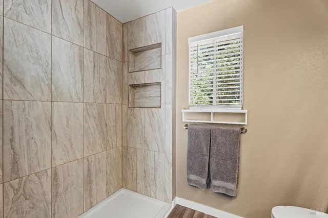 a bathroom with a window and a shower