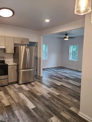 a kitchen with granite countertop a refrigerator and a stove