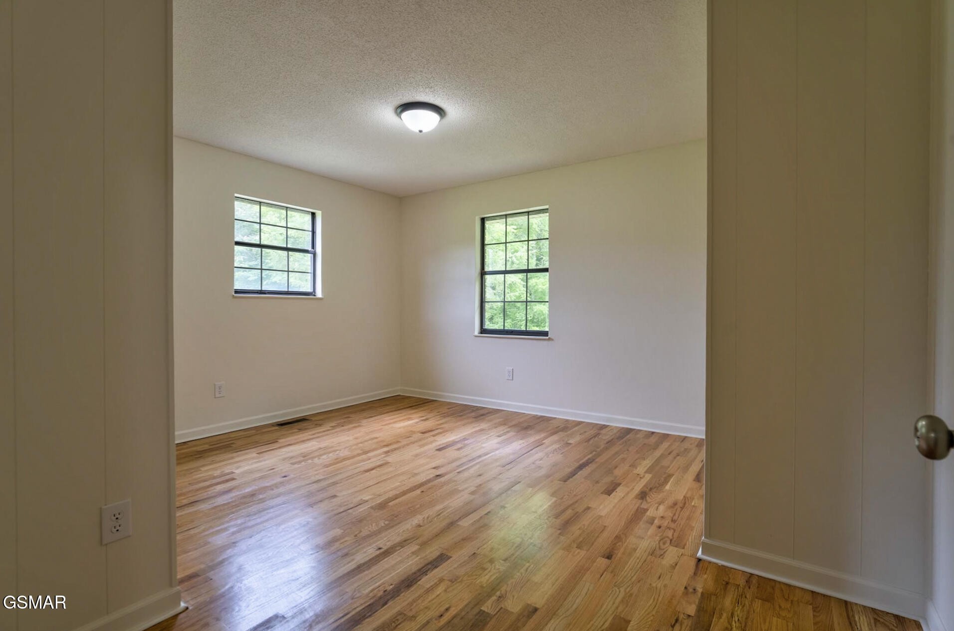 4405 Pearl Valley Road Sevierville, TN 37876 - Photo 15 of 39 an empty room with wooden floor and windows