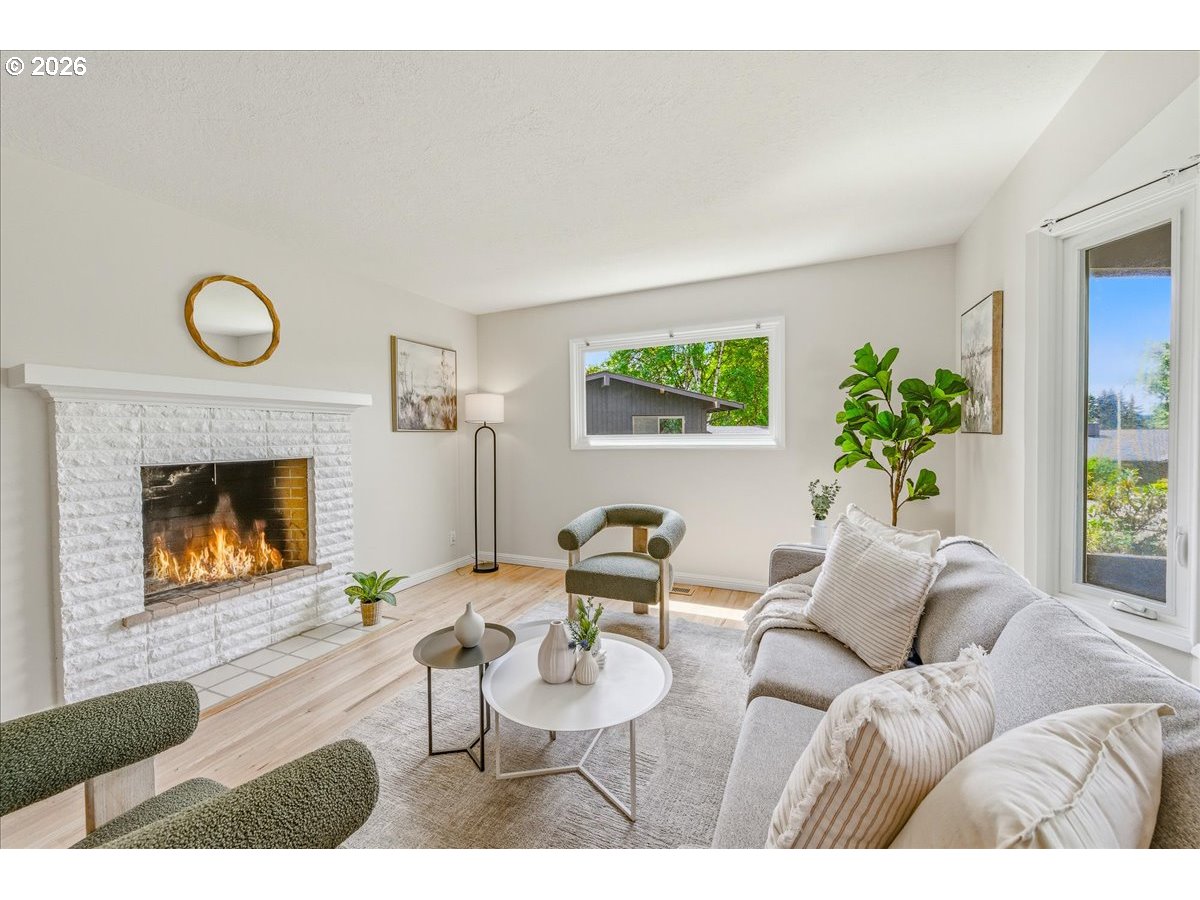3130 Southwest 116th Avenue Beaverton, OR 97005 - Photo 22 of 44 a living room with furniture and a fireplace
