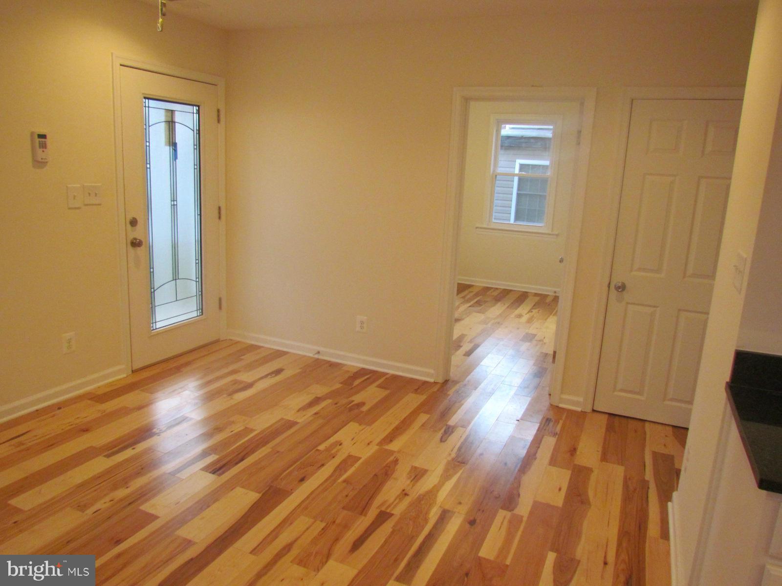 5 Riverside Road Baltimore, MD 21221 - Photo 6 of 28 a view of empty room with wooden floor and fan