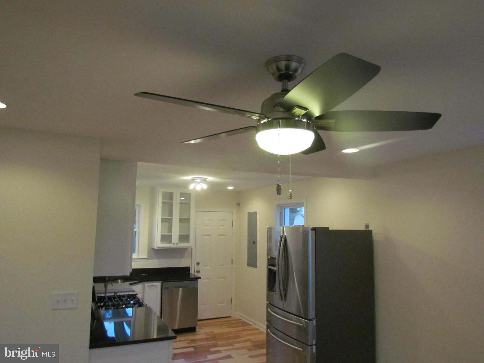5 Riverside Road Baltimore, MD 21221 - Photo 7 of 28 a view of a kitchen with a refrigerator and a ceiling fan