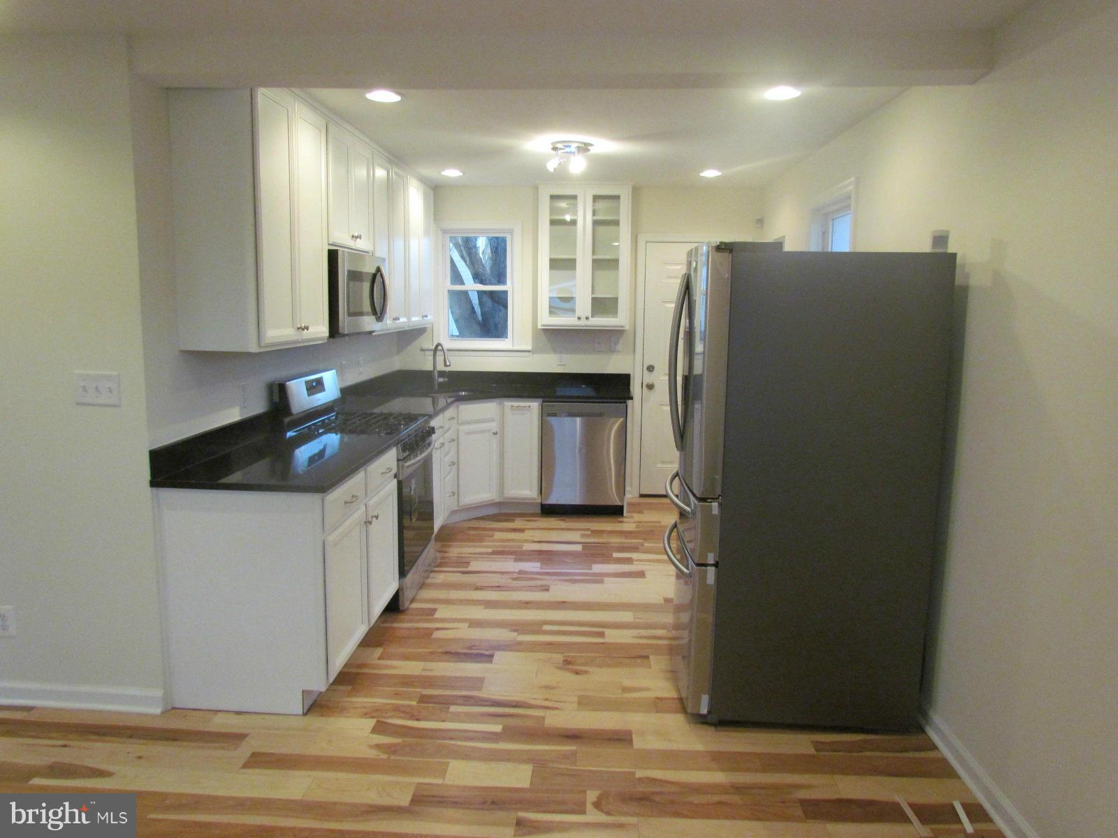 5 Riverside Road Baltimore, MD 21221 - Photo 8 of 28 a kitchen with stainless steel appliances granite countertop a refrigerator and a sink