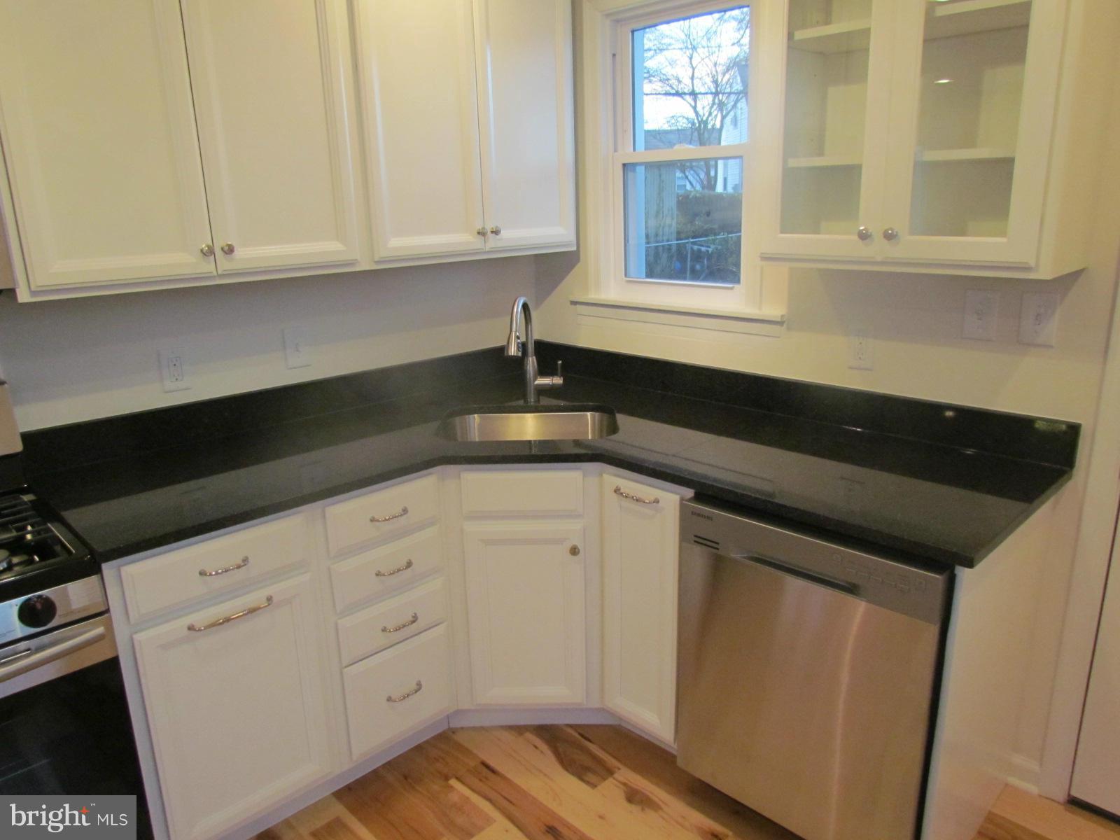 5 Riverside Road Baltimore, MD 21221 - Photo 9 of 28 a kitchen with granite countertop white cabinets and a sink