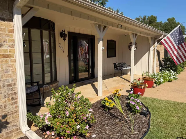a view of a house with a flower garden