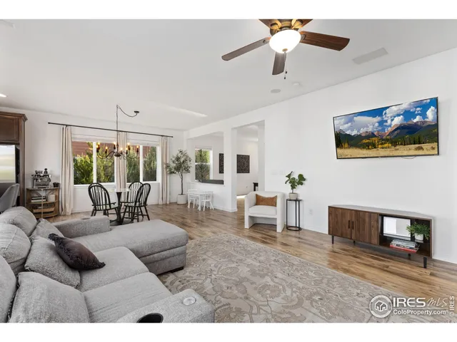 a living room with furniture a fireplace and a chandelier