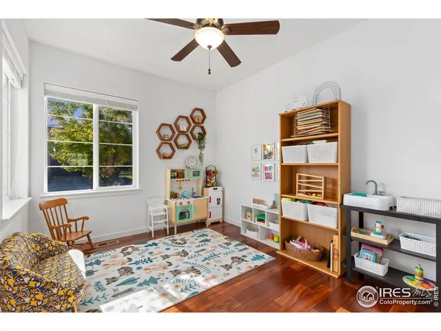 a bedroom with a bed and a book shelf