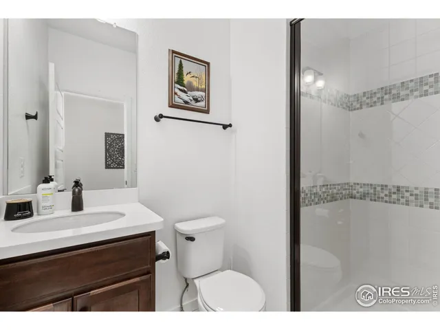 a bathroom with a sink mirror vanity and toilet