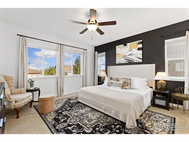 a bedroom with a bed window and couch