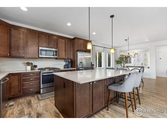 a kitchen with a table chairs sink and cabinets